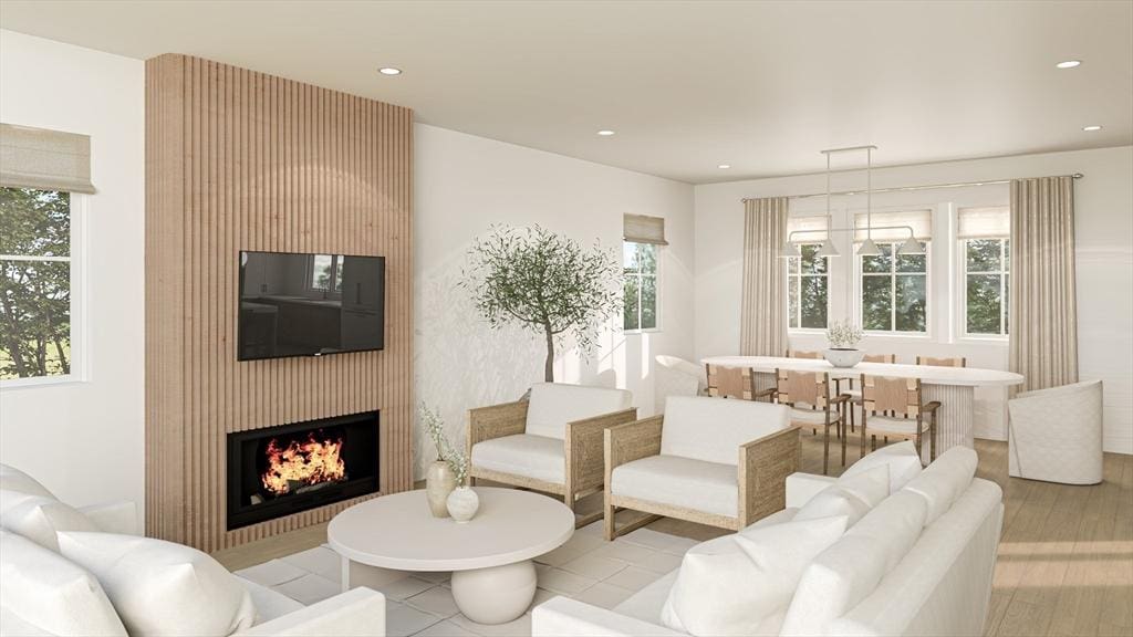 living area with a fireplace, recessed lighting, and a wealth of natural light