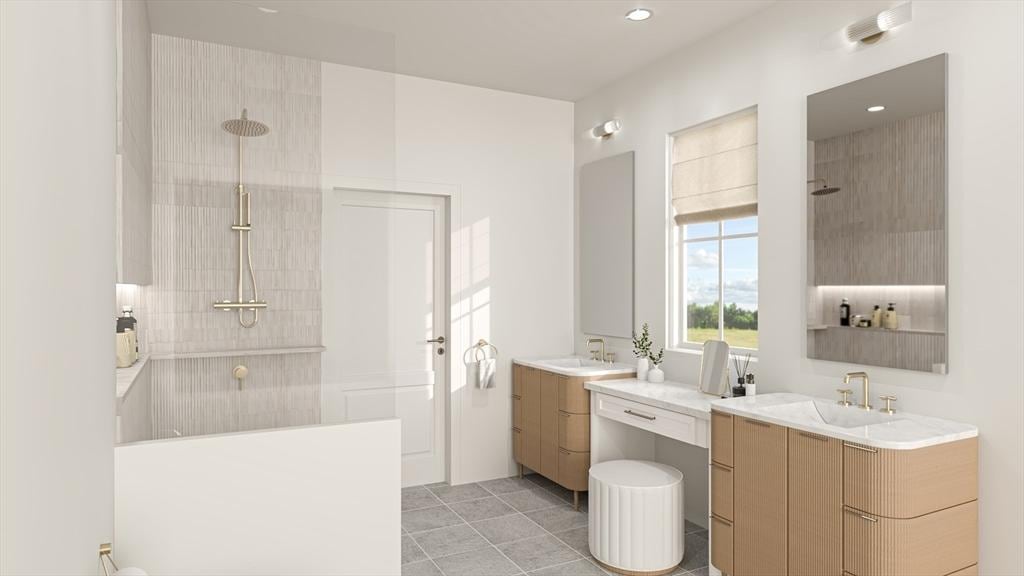 full bathroom with a sink, a walk in shower, and two vanities