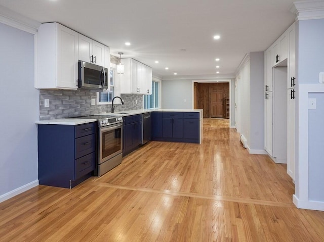 kitchen with blue cabinetry, crown molding, tasteful backsplash, stainless steel appliances, and white cabinets