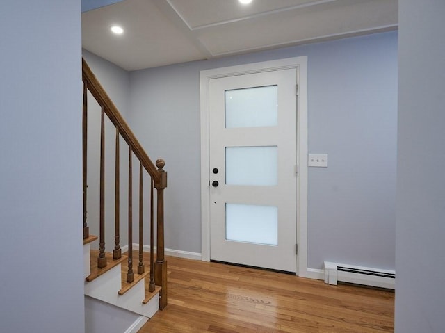 entryway with a baseboard heating unit and light hardwood / wood-style floors