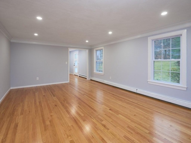 empty room with a baseboard radiator, ornamental molding, light wood-type flooring, and a wealth of natural light