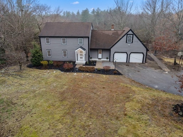 front of property featuring a garage and a front yard