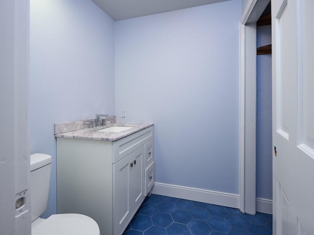 bathroom featuring tile patterned floors, vanity, and toilet