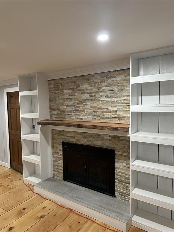 details with a stone fireplace and hardwood / wood-style floors