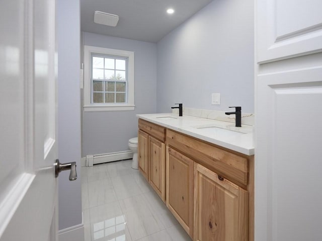 bathroom with vanity, a baseboard heating unit, and toilet