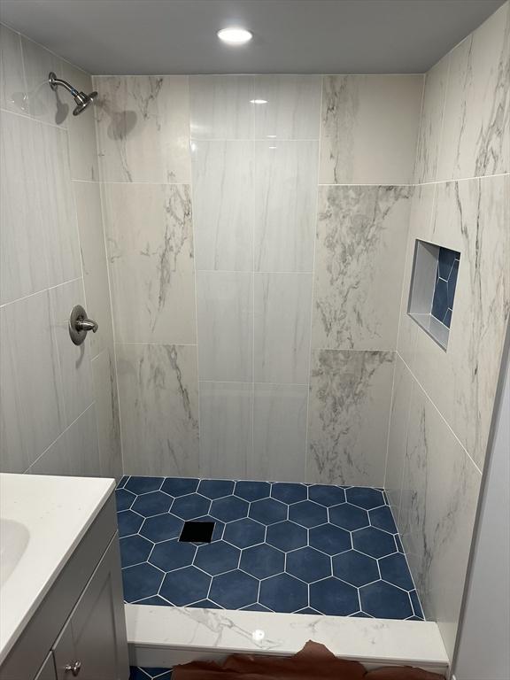 bathroom featuring vanity and a tile shower