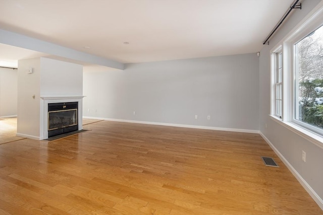 unfurnished living room with light hardwood / wood-style flooring