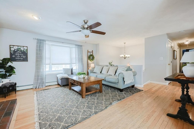 living room with wood-type flooring, ceiling fan with notable chandelier, and a baseboard heating unit