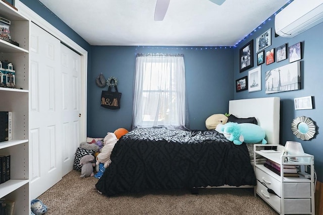 carpeted bedroom with a closet, a wall unit AC, and ceiling fan