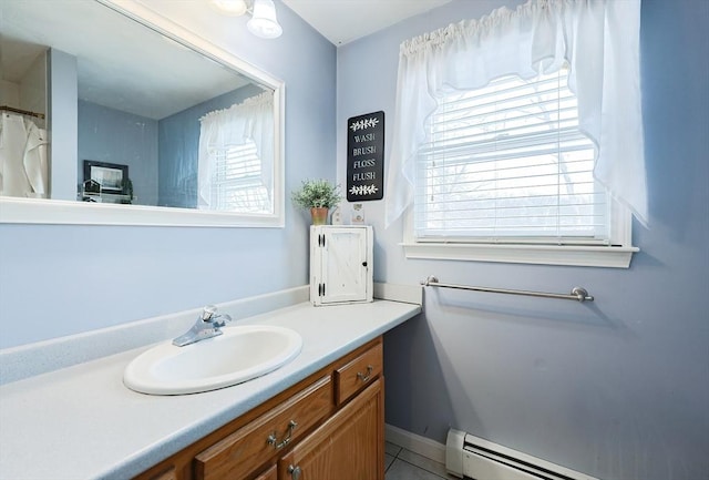 bathroom with tile patterned floors, a baseboard heating unit, and vanity