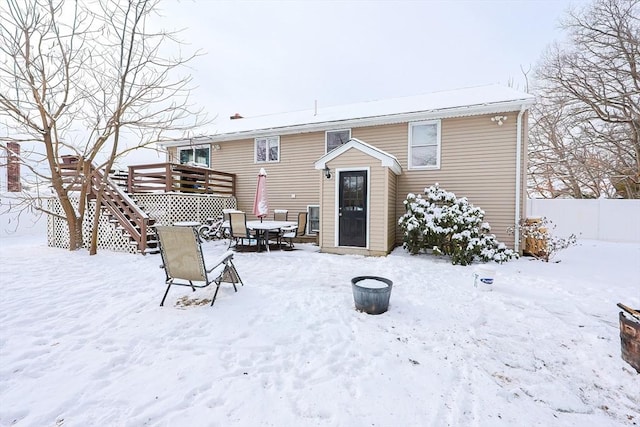 snow covered property featuring a deck