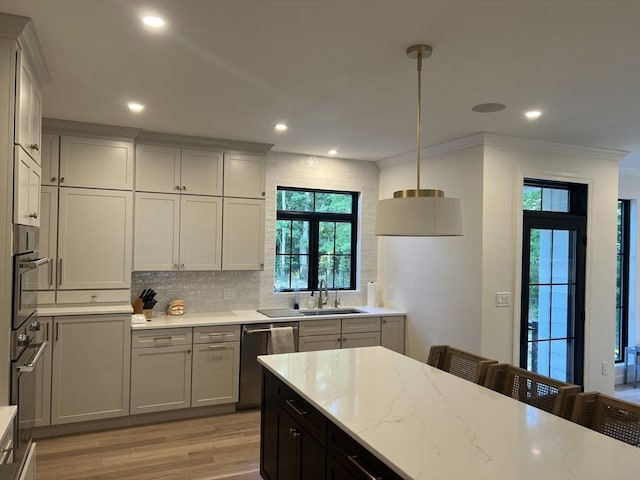 52 Round Farm Rd, Rehoboth, MA 02769 - kitchen with a sink, appliances with stainless steel finishes, light wood finished floors, plenty of natural light, and crown molding