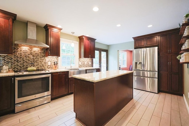 54 Mountain View Rd, Leominster, MA 01453 - kitchen featuring stainless steel appliances, wall chimney range hood, a sink, decorative backsplash, and light wood finished floors