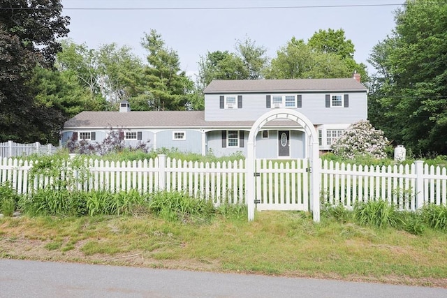 54 Mountain View Rd, Leominster, MA 01453 - view of front of home with a chimney, a fenced front yard, and view of wooded area