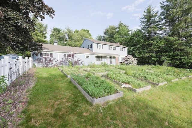 54 Mountain View Rd, Leominster, MA 01453 - back of property with a vegetable garden and a chimney