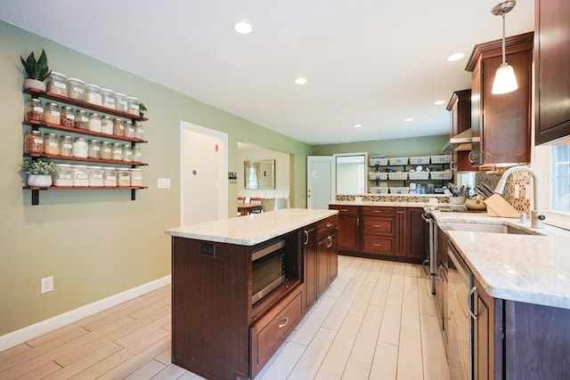 54 Mountain View Rd, Leominster, MA 01453 - kitchen featuring light wood finished floors, a kitchen island, a sink, light stone countertops, and stainless steel appliances