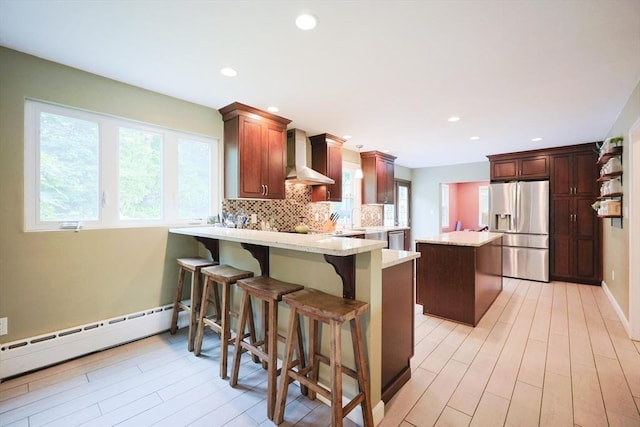 54 Mountain View Rd, Leominster, MA 01453 - kitchen with appliances with stainless steel finishes, wall chimney range hood, a peninsula, plenty of natural light, and recessed lighting