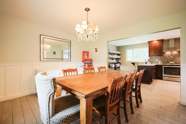 54 Mountain View Rd, Leominster, MA 01453 - dining room featuring a chandelier, light wood-style floors, wainscoting, and a decorative wall