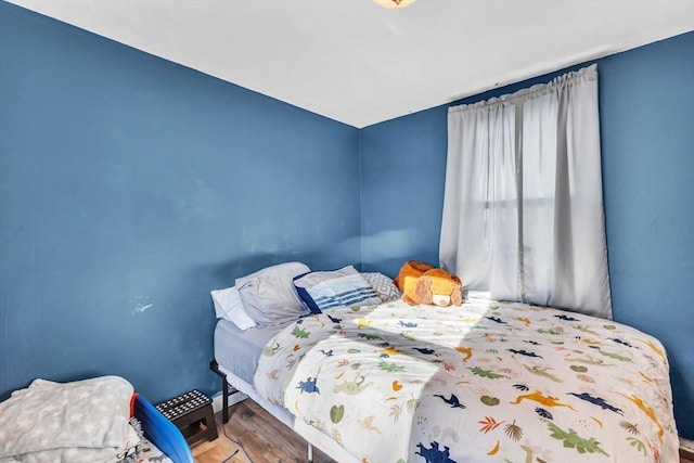 bedroom with wood-type flooring