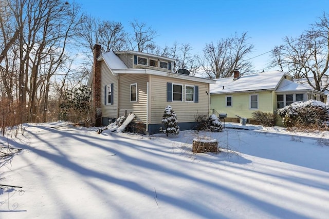 view of snow covered rear of property