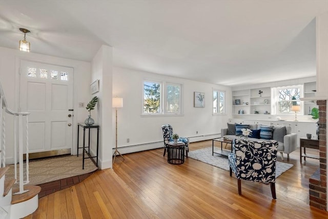 foyer with a baseboard radiator and light wood-type flooring