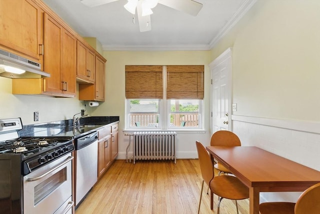 6-R Hazel Ter Unit 6, Salem, MA 01970 - kitchen featuring appliances with stainless steel finishes, radiator heating unit, under cabinet range hood, a ceiling fan, and dark countertops