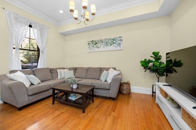 living area with crown molding, light wood-style floors, baseboards, and a chandelier