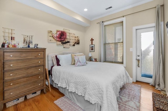 bedroom featuring visible vents, light wood finished floors, recessed lighting, ornamental molding, and access to outside