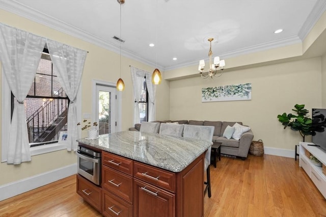 kitchen with visible vents, light stone countertops, light wood-type flooring, ornamental molding, and stainless steel oven