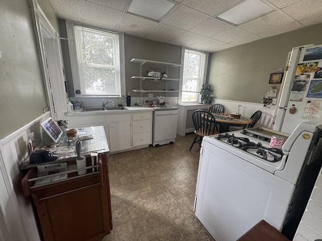 39 Newbury Ave, Quincy, MA 02171 - kitchen featuring a sink, white range with gas cooktop, white cabinetry, a drop ceiling, and light countertops