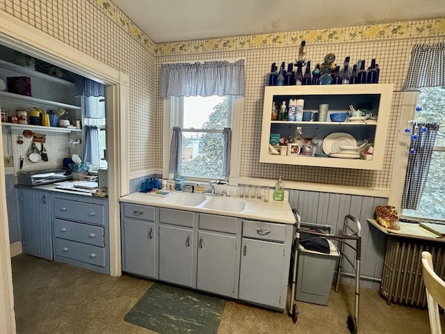 39 Newbury Ave, Quincy, MA 02171 - kitchen with wallpapered walls, gray cabinets, a sink, open shelves, and carpet