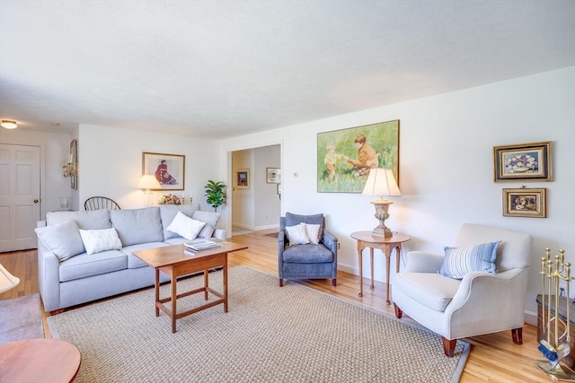 living area with light wood-style floors and baseboards