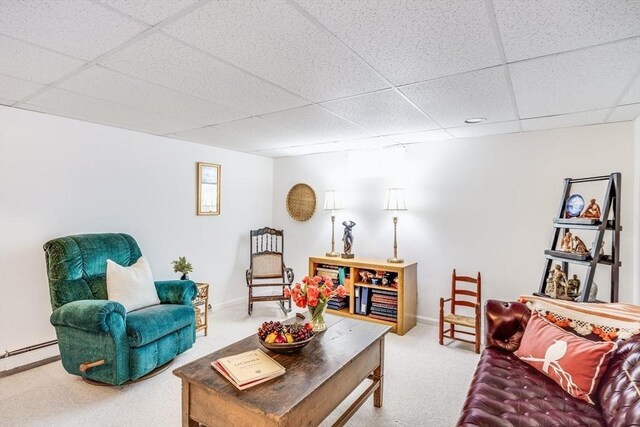 living room with baseboards, a baseboard radiator, carpet flooring, and a paneled ceiling