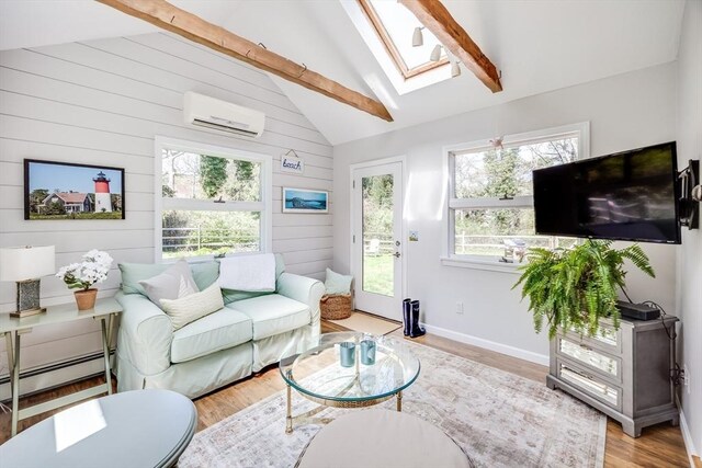 living room with vaulted ceiling with skylight, wood walls, a wall mounted air conditioner, a baseboard radiator, and light wood-style flooring