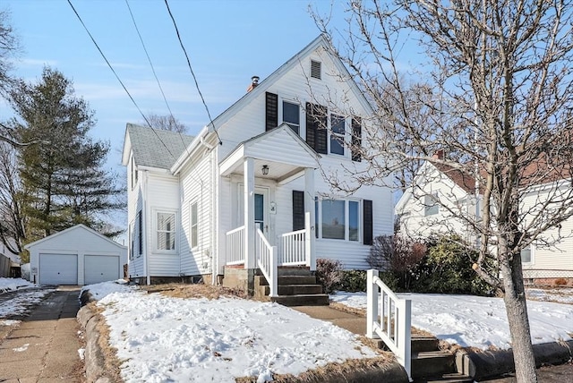 view of front of home featuring a garage and an outbuilding