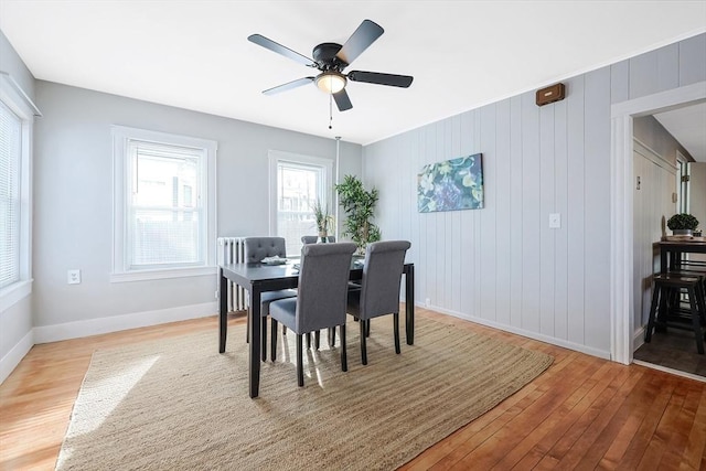 dining area with ceiling fan and light wood-type flooring