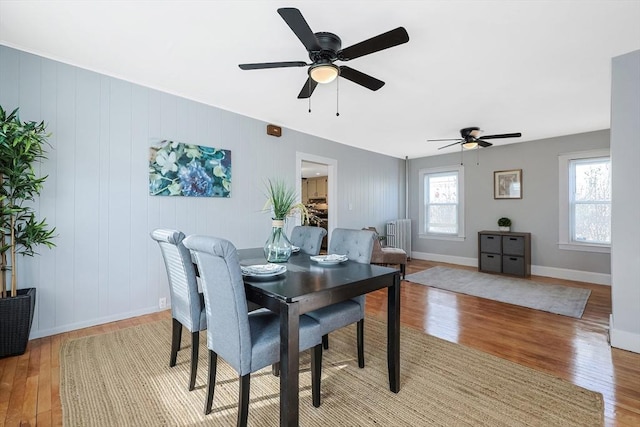 dining area featuring radiator and light wood-type flooring