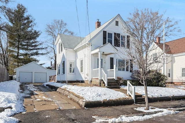 view of front of house with a garage and an outdoor structure