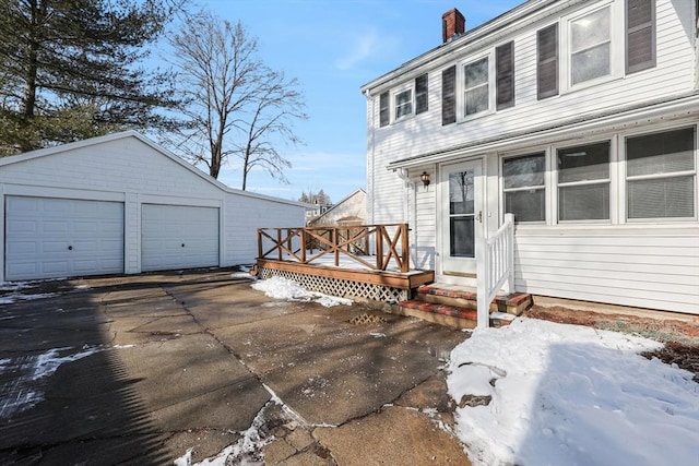 view of front of home with an outbuilding, a garage, and a deck