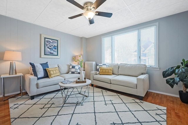 living room with ceiling fan, wood-type flooring, and radiator