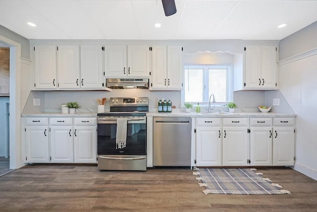 kitchen featuring dark wood-type flooring, sink, ceiling fan, stainless steel appliances, and white cabinets