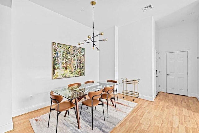 203 Middle St Unit 6, Weymouth, MA 02189 - dining room with light wood-style flooring, a chandelier, and baseboards