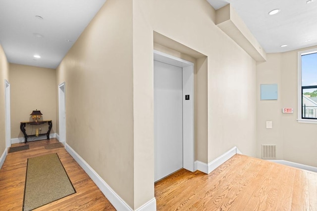203 Middle St Unit 6, Weymouth, MA 02189 - hallway with wood finished floors, elevator, baseboards, and recessed lighting