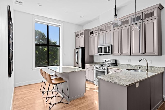 203 Middle St Unit 6, Weymouth, MA 02189 - kitchen featuring stainless steel appliances, a sink, a kitchen bar, light wood-type flooring, and recessed lighting