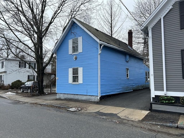 view of side of property with a chimney