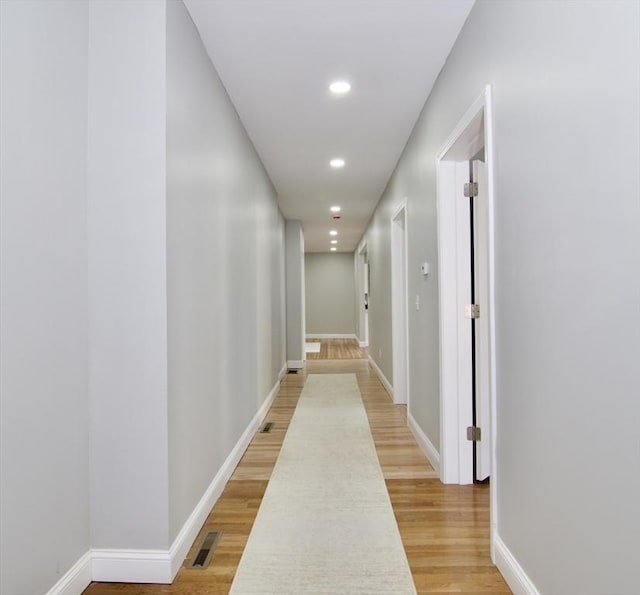 hallway with hardwood / wood-style floors