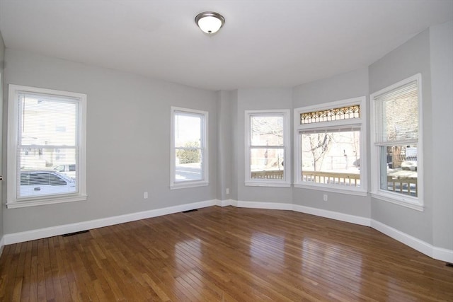 empty room with dark wood-type flooring