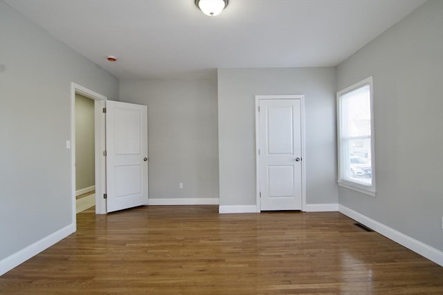 unfurnished bedroom featuring hardwood / wood-style floors