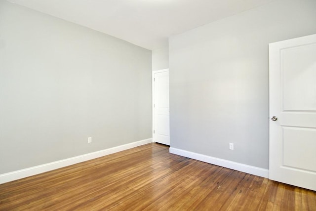 unfurnished room with hardwood / wood-style floors