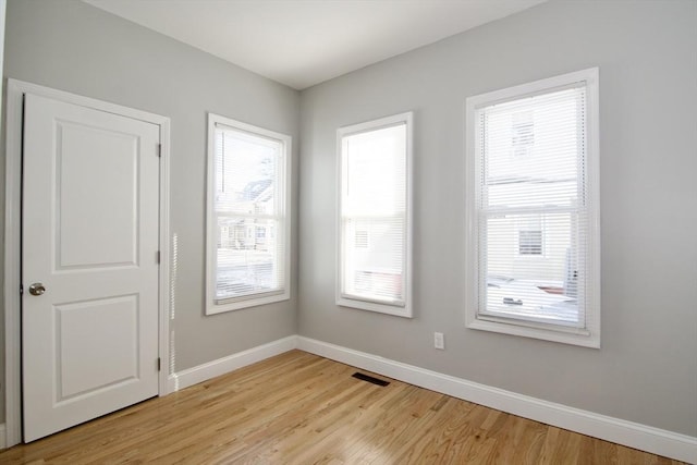 unfurnished room with light wood-type flooring